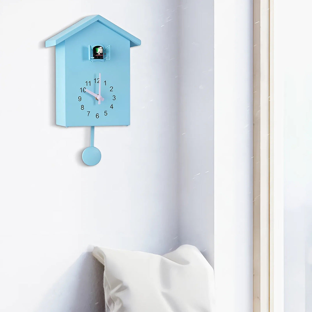 "Minimalist cuckoo wall clock with sleek black and white finish, modern design, whimsical bird element, compact 20x25cm size.