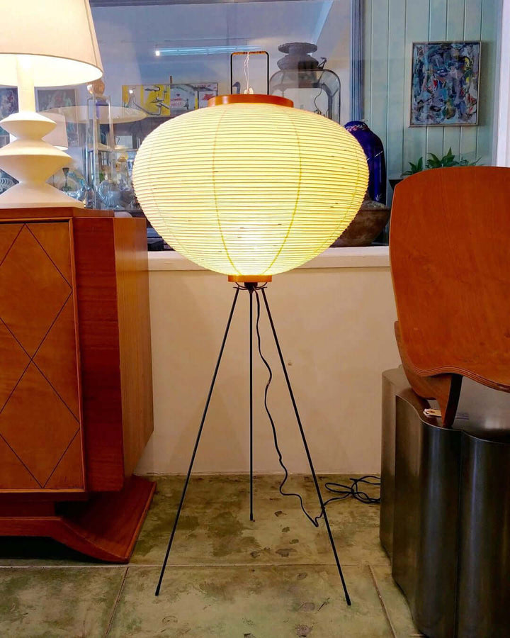 "Minimalist rice paper floor lamp with sleek metal frame and soft diffused light, perfect for creating a warm ambiance."