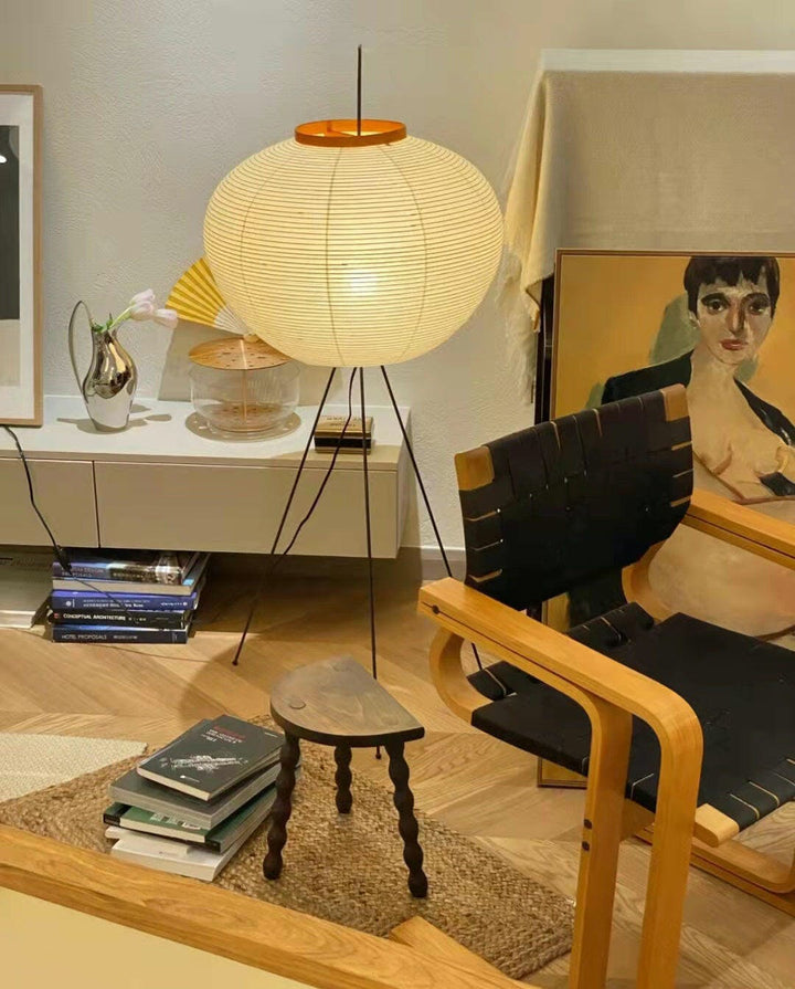 "Minimalist rice paper floor lamp with sleek metal frame and soft diffused light, perfect for creating a warm ambiance."