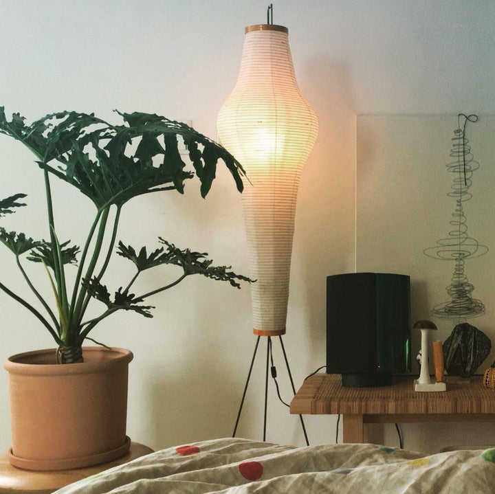"Minimalist rice paper floor lamp with sleek metal frame and soft diffused light, perfect for creating a warm ambiance."