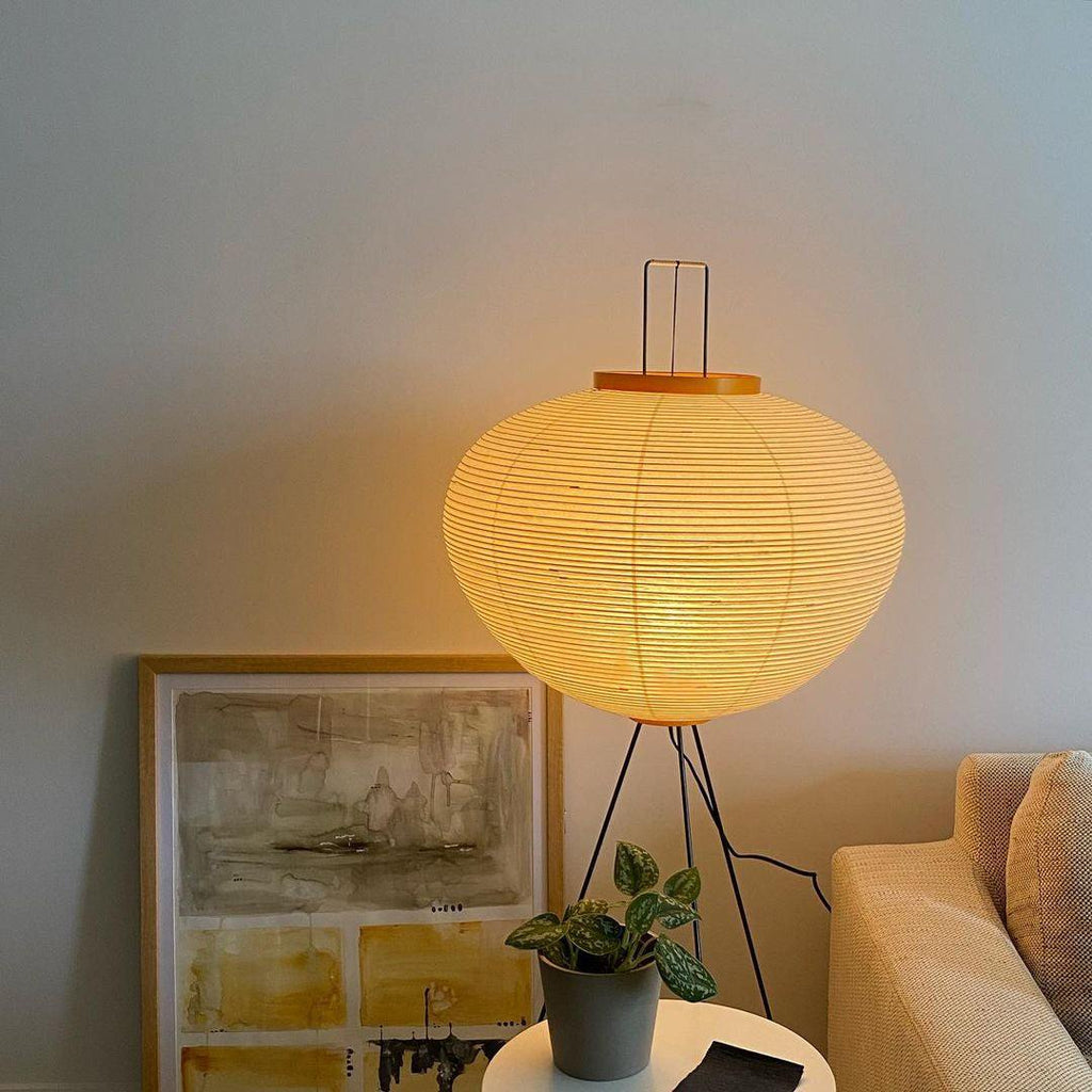 "Minimalist rice paper floor lamp with sleek metal frame and soft diffused light, perfect for creating a warm ambiance."