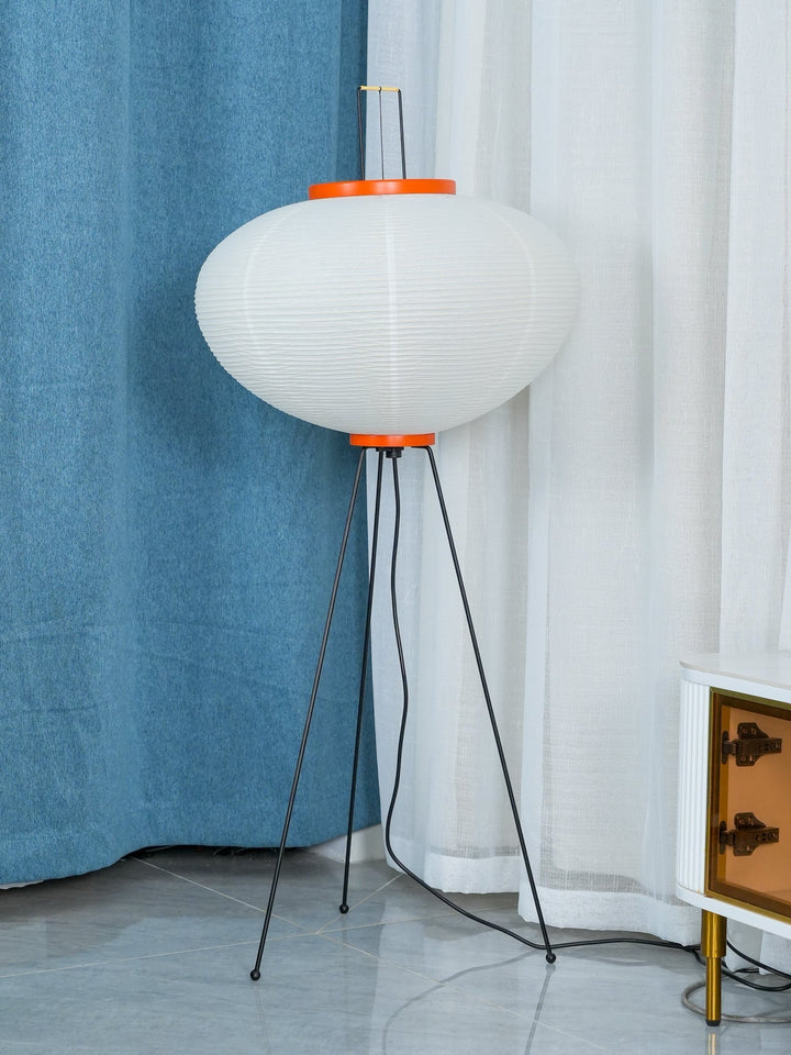 "Minimalist rice paper floor lamp with sleek metal frame and soft diffused light, perfect for creating a warm ambiance."