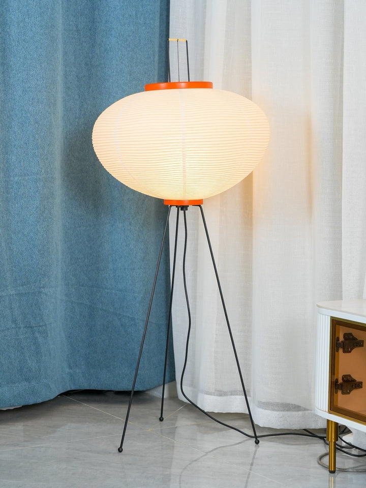 "Minimalist rice paper floor lamp with sleek metal frame and soft diffused light, perfect for creating a warm ambiance."