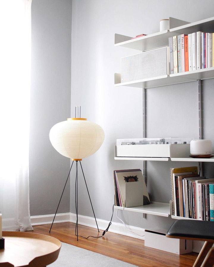 "Minimalist rice paper floor lamp with sleek metal frame and soft diffused light, perfect for creating a warm ambiance."