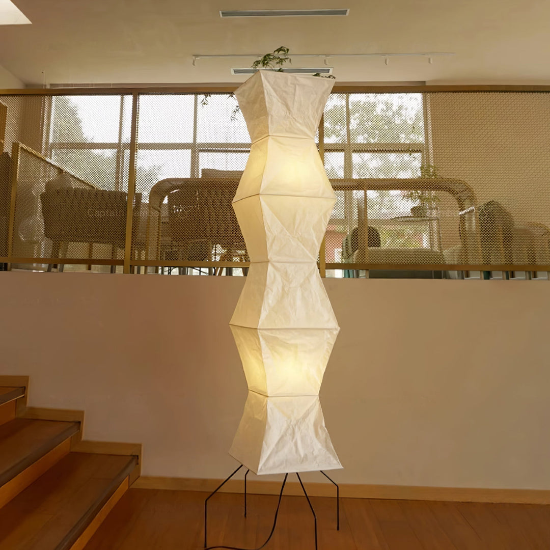 "Minimalist rice paper floor lamp with sleek metal frame and soft diffused light, perfect for creating a warm ambiance."