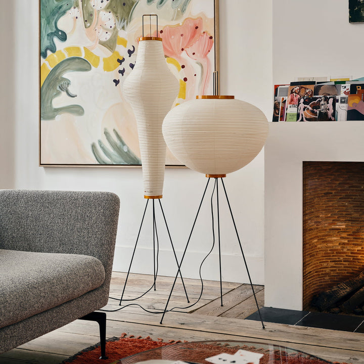 "Minimalist rice paper floor lamp with sleek metal frame and soft diffused light, perfect for creating a warm ambiance."