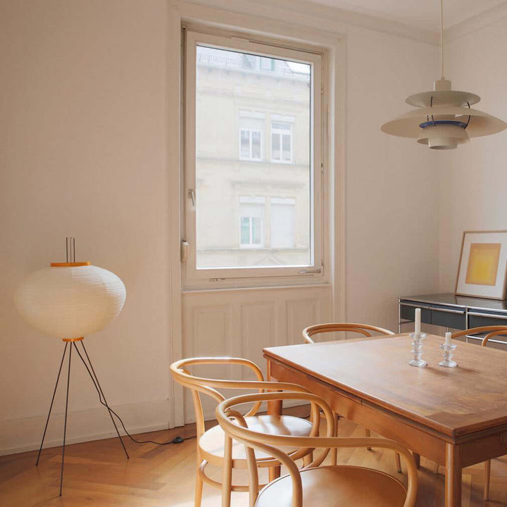 "Minimalist rice paper floor lamp with sleek metal frame and soft diffused light, perfect for creating a warm ambiance."