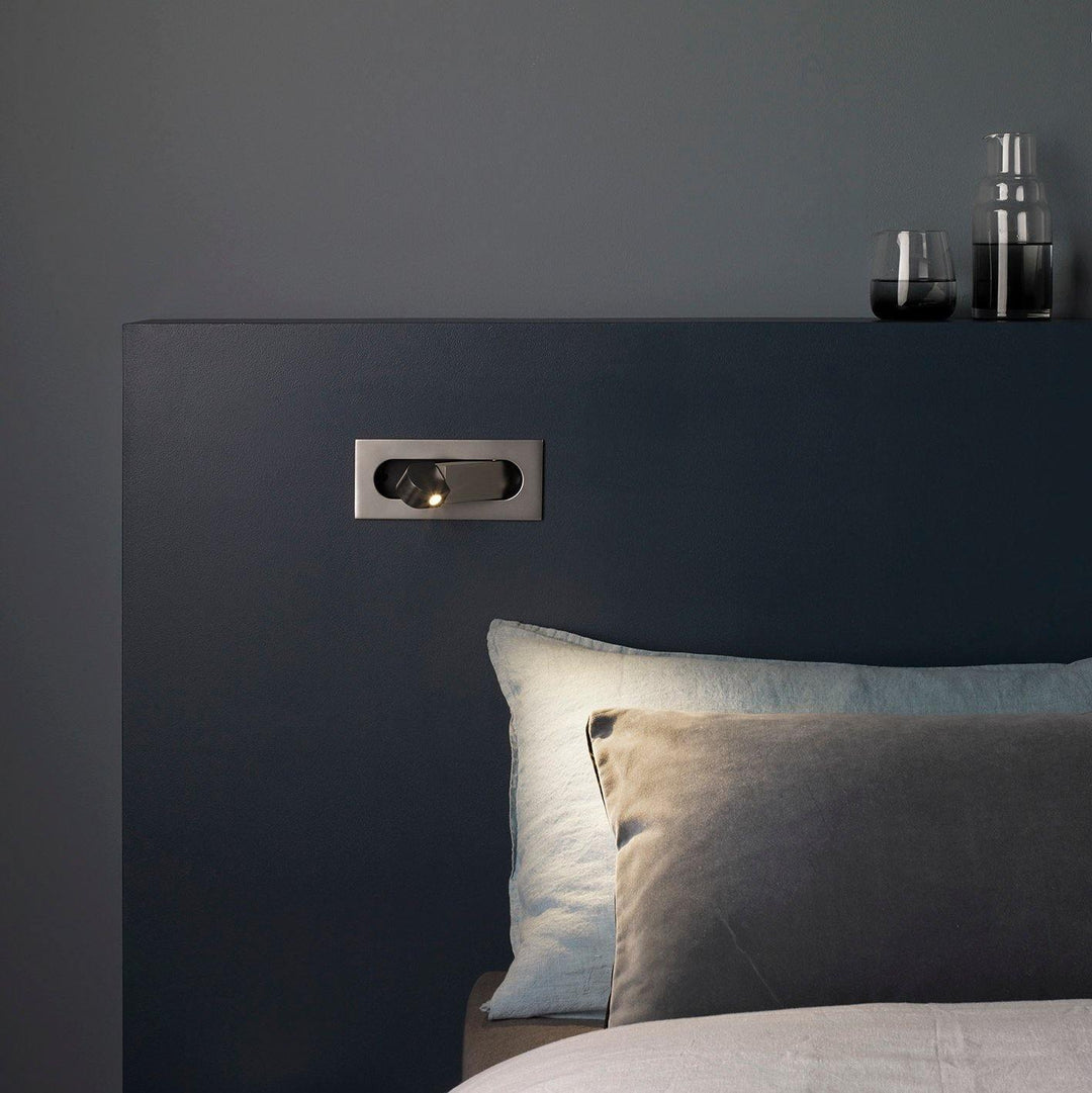 Modern adjustable LED bedside lamp in matte black with a sleek design, featuring an adjustable head for focused reading light