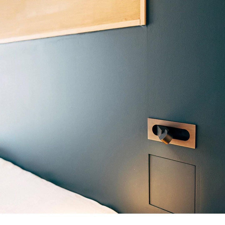 Modern adjustable LED bedside lamp in matte black with a sleek design, featuring an adjustable head for focused reading light
