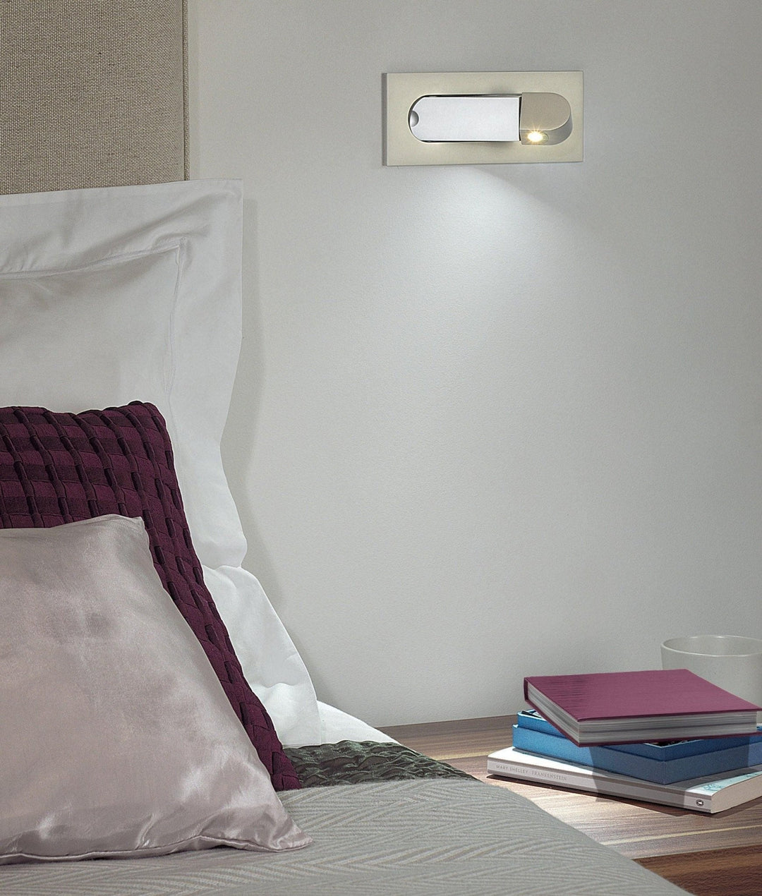 Modern adjustable LED bedside lamp in matte black with a sleek design, featuring an adjustable head for focused reading light