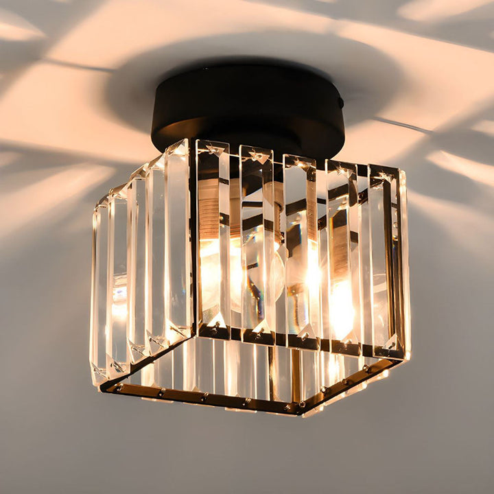 Modern black crystal flush mount ceiling light, sleek brass fixture, crystal shade, ideal for rooms with low ceilings.