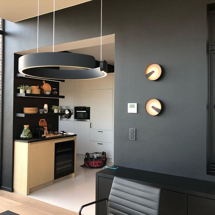 "Modern circular LED pendant light in minimal design, black finish, ideal for elegant home interiors and efficient lighting."
