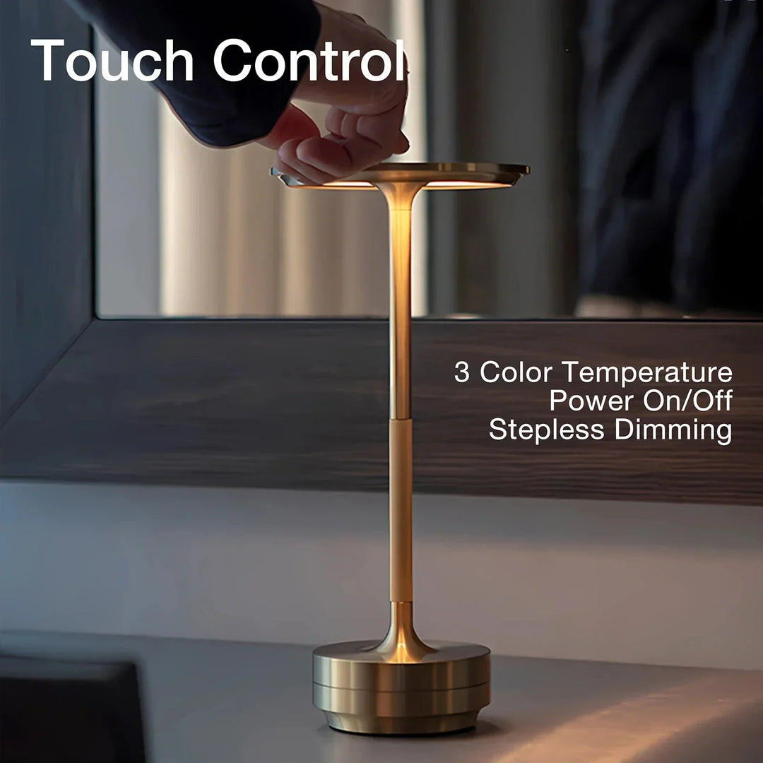 Modern cordless table lamp with touch control, Nordic design, gold frame, brushed finish, illuminating a stylish room.