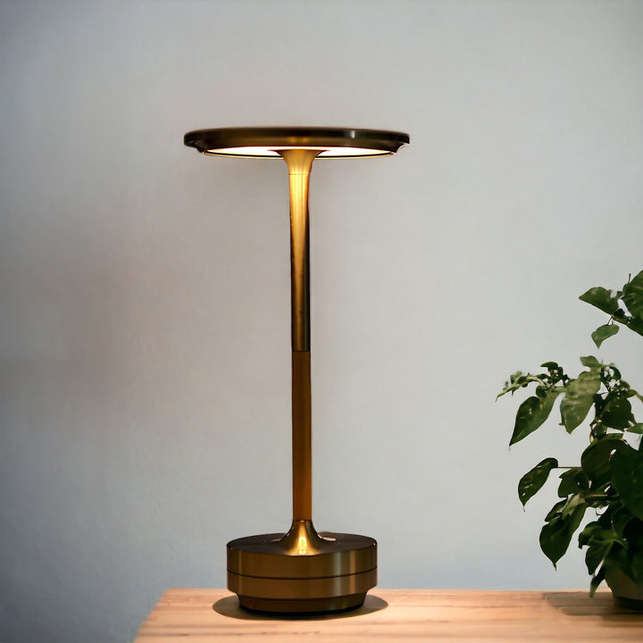 Modern cordless table lamp with touch control, Nordic design, gold frame, brushed finish, illuminating a stylish room.