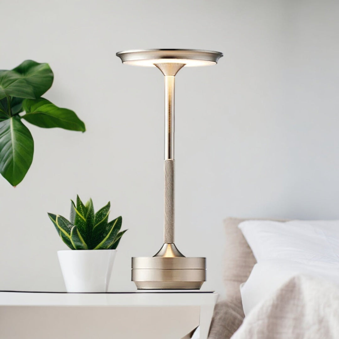 Modern cordless table lamp with touch control, Nordic design, gold frame, brushed finish, illuminating a stylish room.