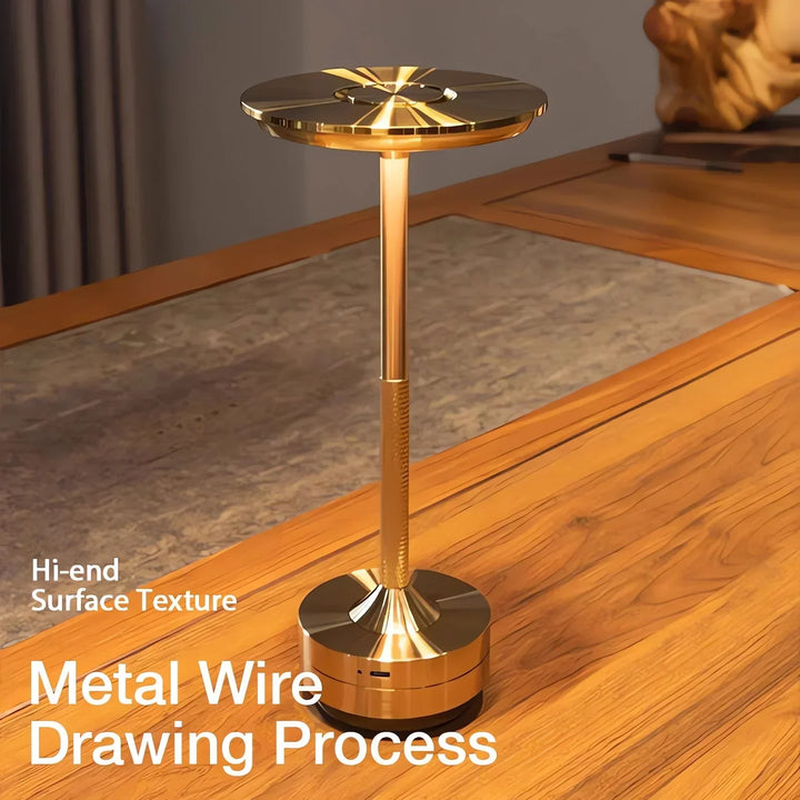Modern cordless table lamp with touch control, Nordic design, gold frame, brushed finish, illuminating a stylish room.