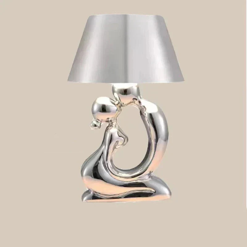 Contemporary silver table lamp, a modern designer piece. Elegant lighting solution for any home, office, or bedroom.