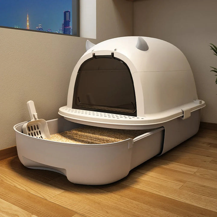 "Modern enclosed cat litter box with swing door, pull-out tray, high walls in grey and white, stylish pet supplies solution."