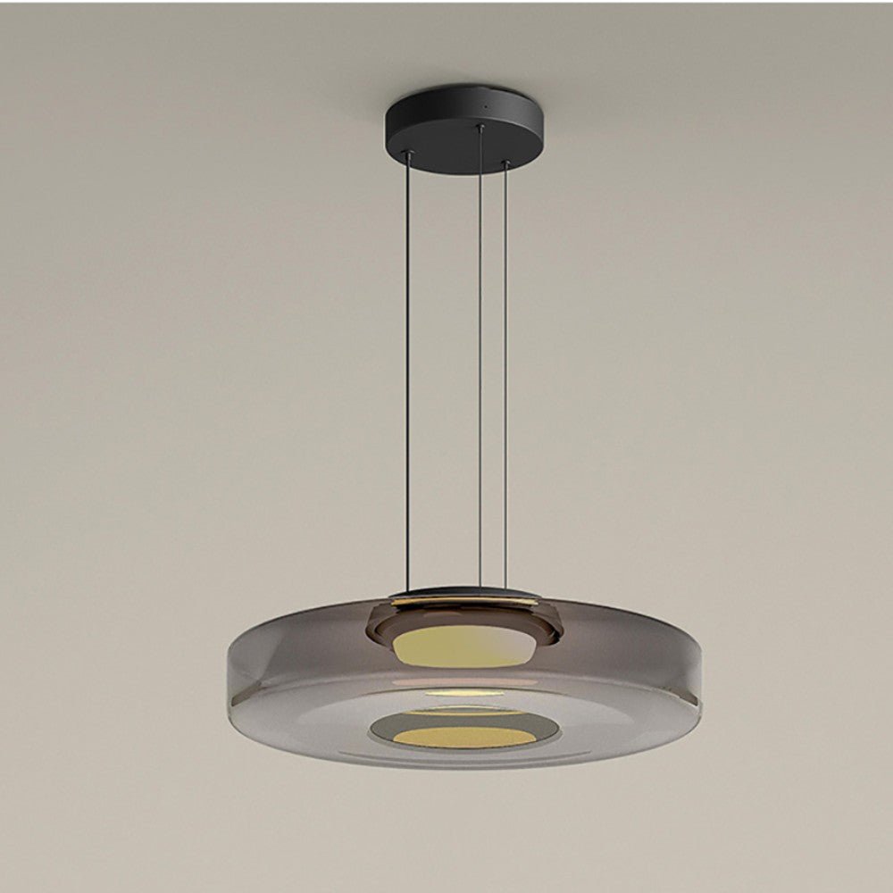 "Modern glass pendant lamp in Bauhaus design, smoke grey shade, adjustable cable, warm LED glow, ideal for home interiors."