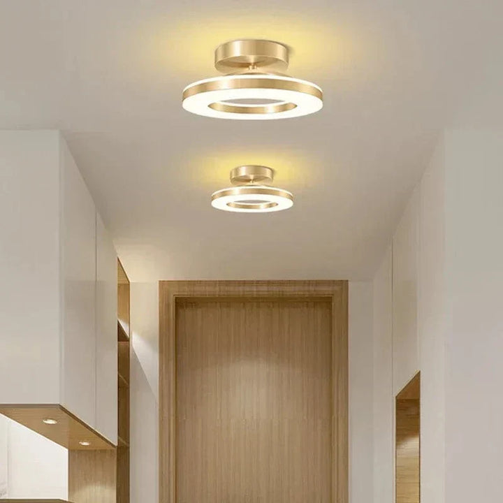 "Modern LED ceiling light with adjustable colors, sleek design, gold and black finish, perfect for contemporary interiors."