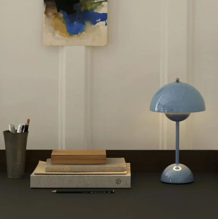 Soft glow from a modern LED touch-control lamp, ideal for comfortable bedroom reading or mood lighting.