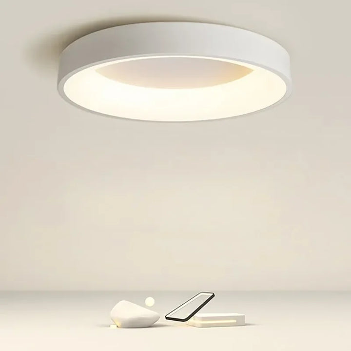 "Modern Nordic LED ceiling light with sleek round design in black, white, and gray for stylish minimalistic home decor."