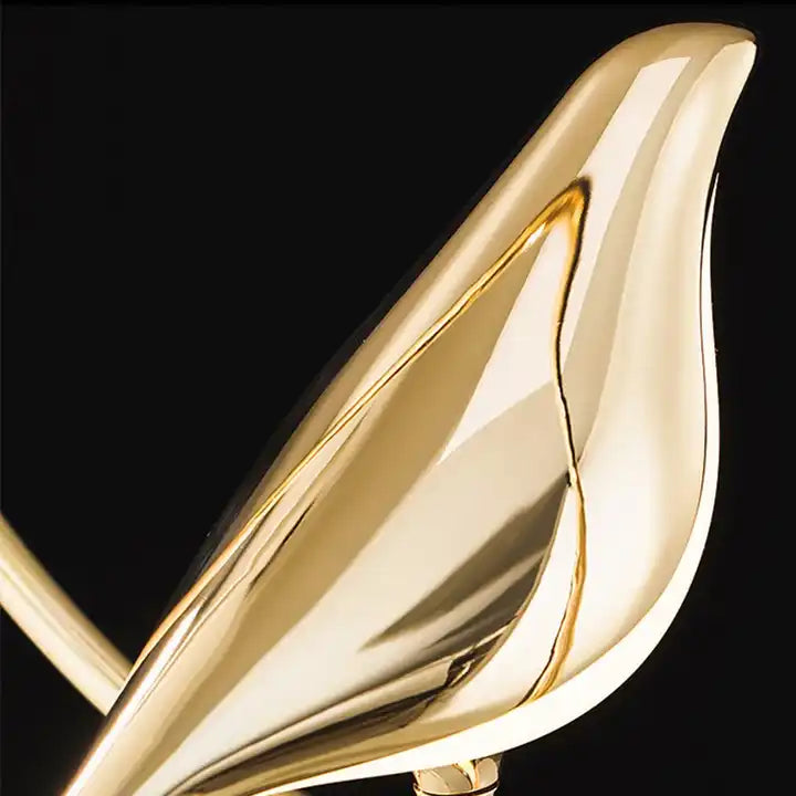 "Modern pendant light with elegant golden bird design in a minimalist frame, ideal for serene home environments."