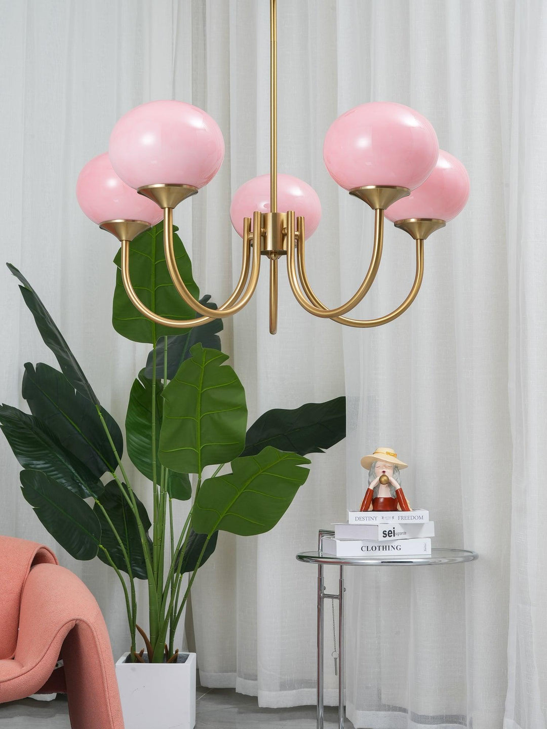 Modern pink and gold chandelier with elegant glass shades, ideal ceiling light fixture for chic home decor and illumination.