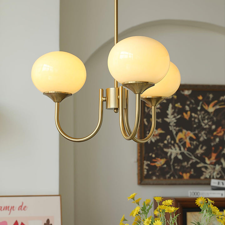 Modern pink and gold chandelier with elegant glass shades, ideal ceiling light fixture for chic home decor and illumination.