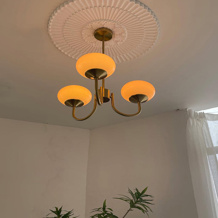 Modern pink and gold chandelier with elegant glass shades, ideal ceiling light fixture for chic home decor and illumination.