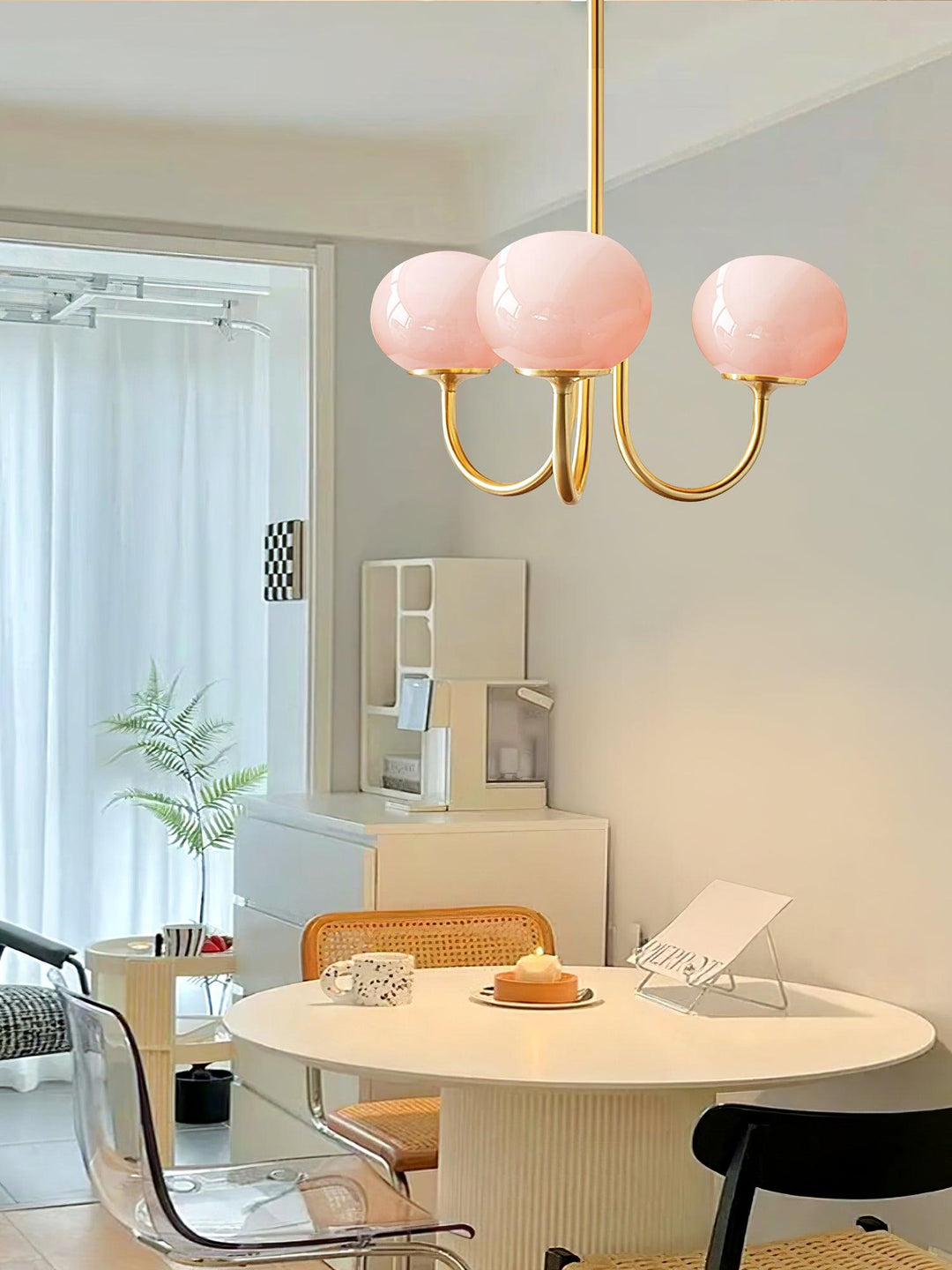 Modern pink and gold chandelier with elegant glass shades, ideal ceiling light fixture for chic home decor and illumination.