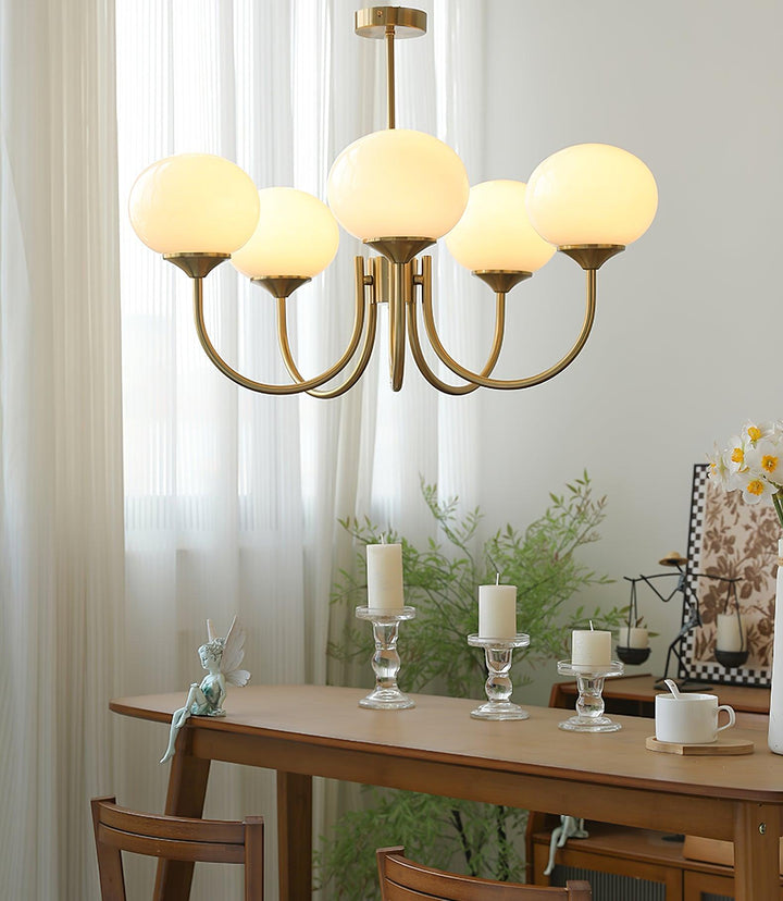 Modern pink and gold chandelier with elegant glass shades, ideal ceiling light fixture for chic home decor and illumination.
