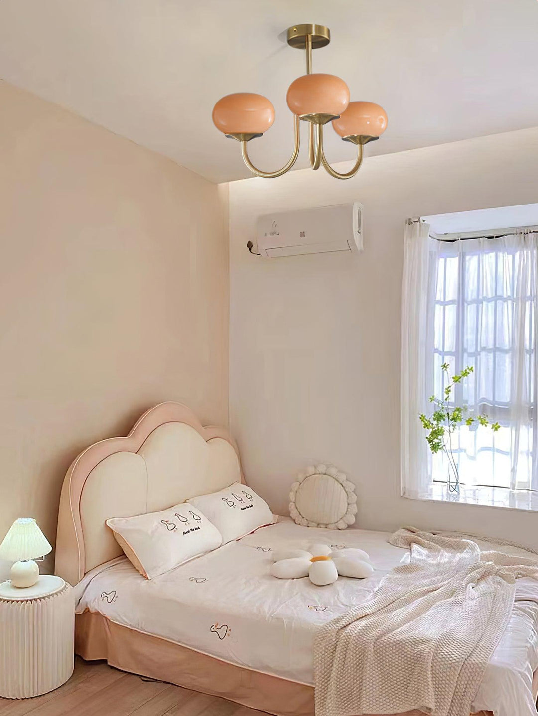Modern pink and gold chandelier with elegant glass shades, ideal ceiling light fixture for chic home decor and illumination.