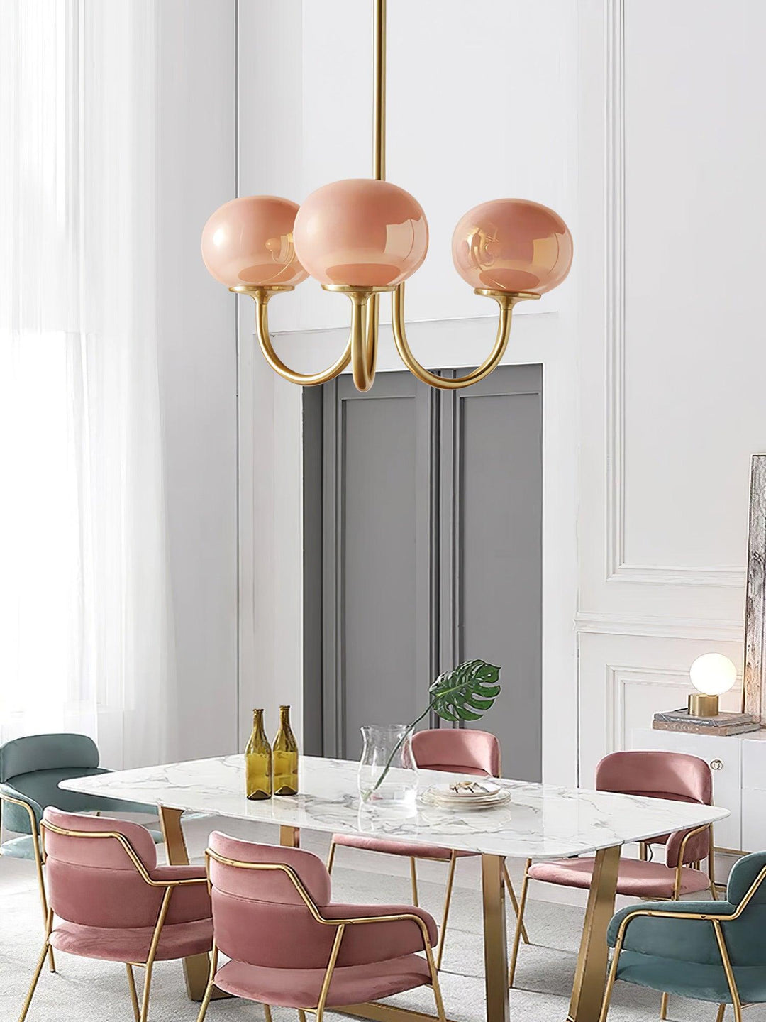 Modern pink and gold chandelier with elegant glass shades, ideal ceiling light fixture for chic home decor and illumination.