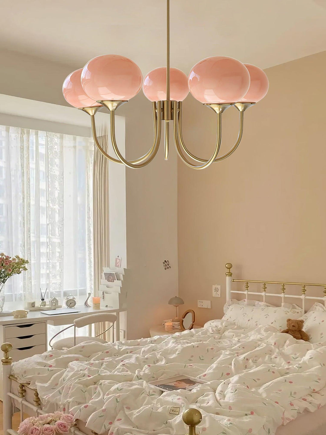 Modern pink and gold chandelier with elegant glass shades, ideal ceiling light fixture for chic home decor and illumination.
