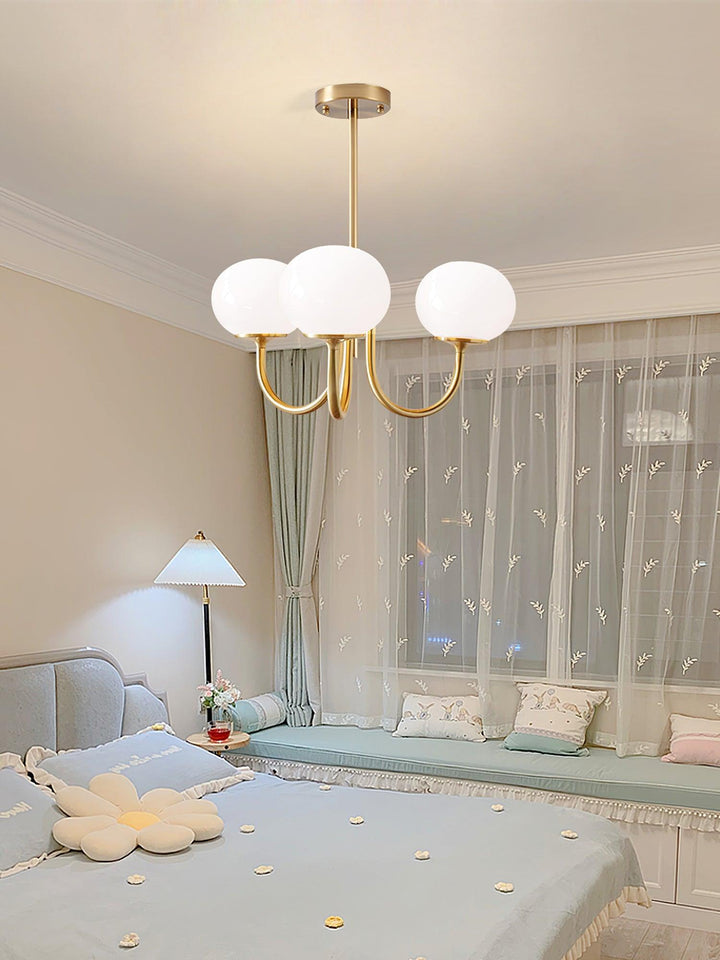 Modern pink and gold chandelier with elegant glass shades, ideal ceiling light fixture for chic home decor and illumination.