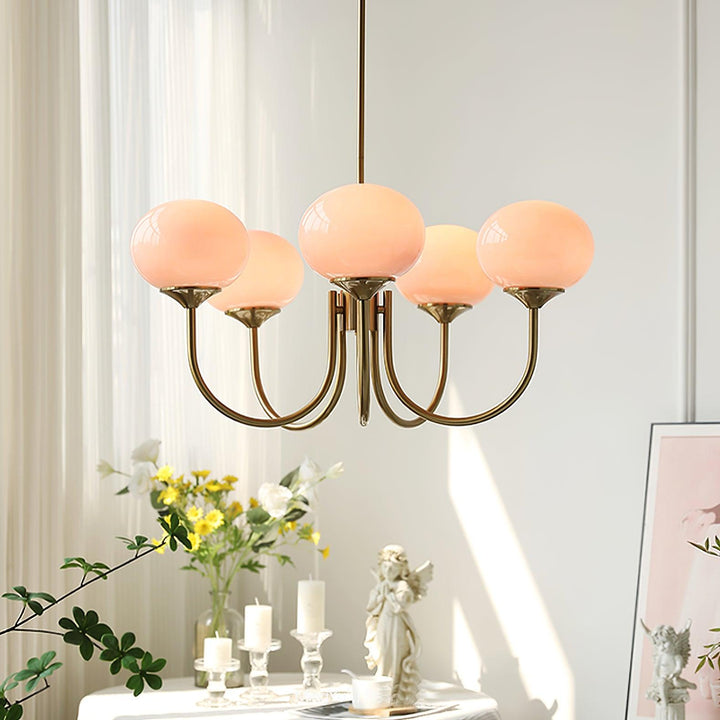 Modern pink and gold chandelier with elegant glass shades, ideal ceiling light fixture for chic home decor and illumination.