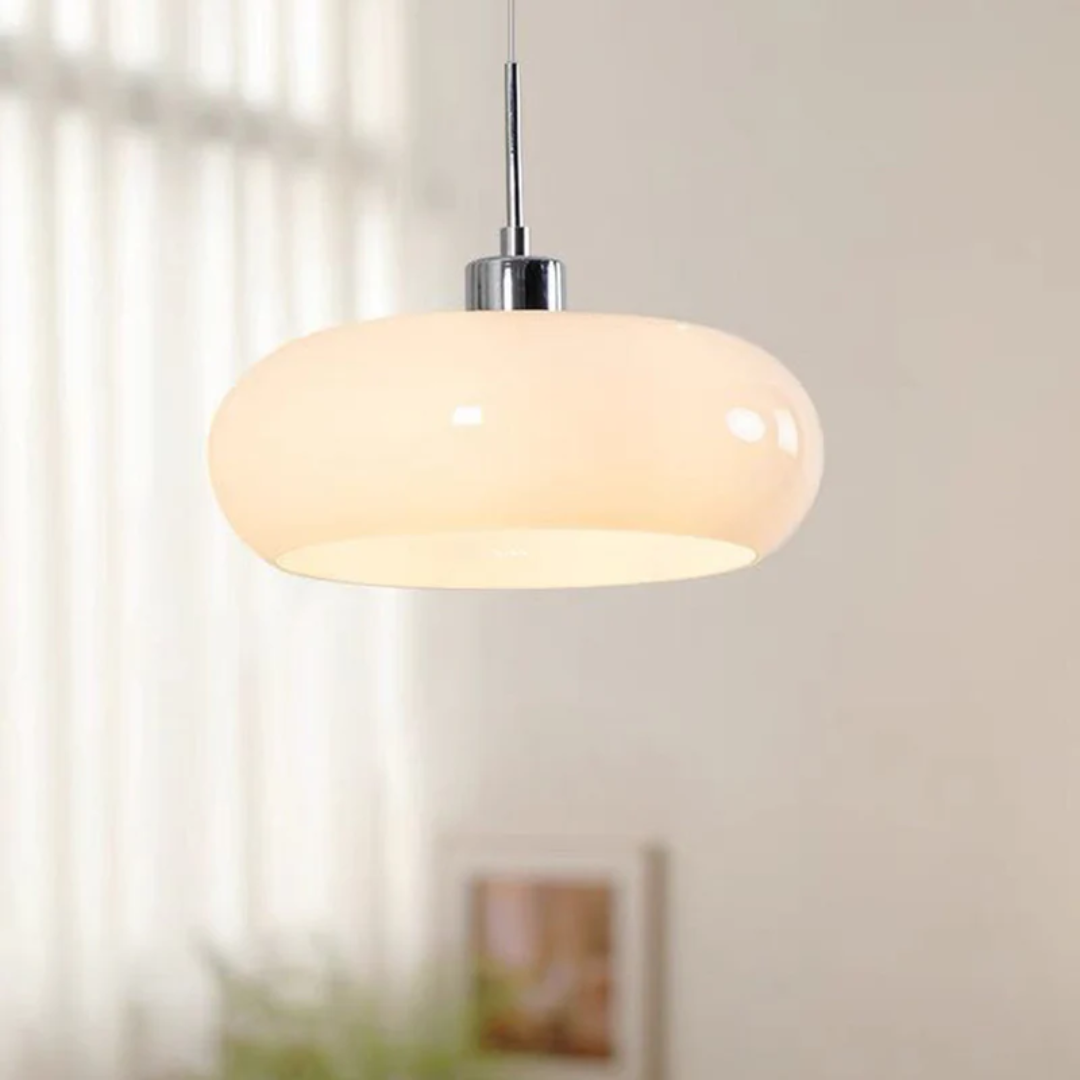 Sleek round LED pendant light, RadianceOrb, providing warm white illumination for a cozy living room ambiance.