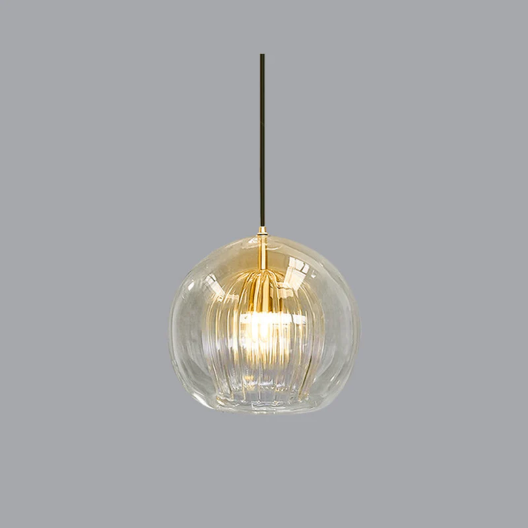 Modern sphere LED pendant light with a clear glass shade, emitting warm white ambient light for contemporary home decor.