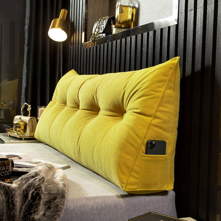 "Multi-coloured ergonomic wedge pillow for back support; shown in brown, yellow, and orange with a handy side pocket."