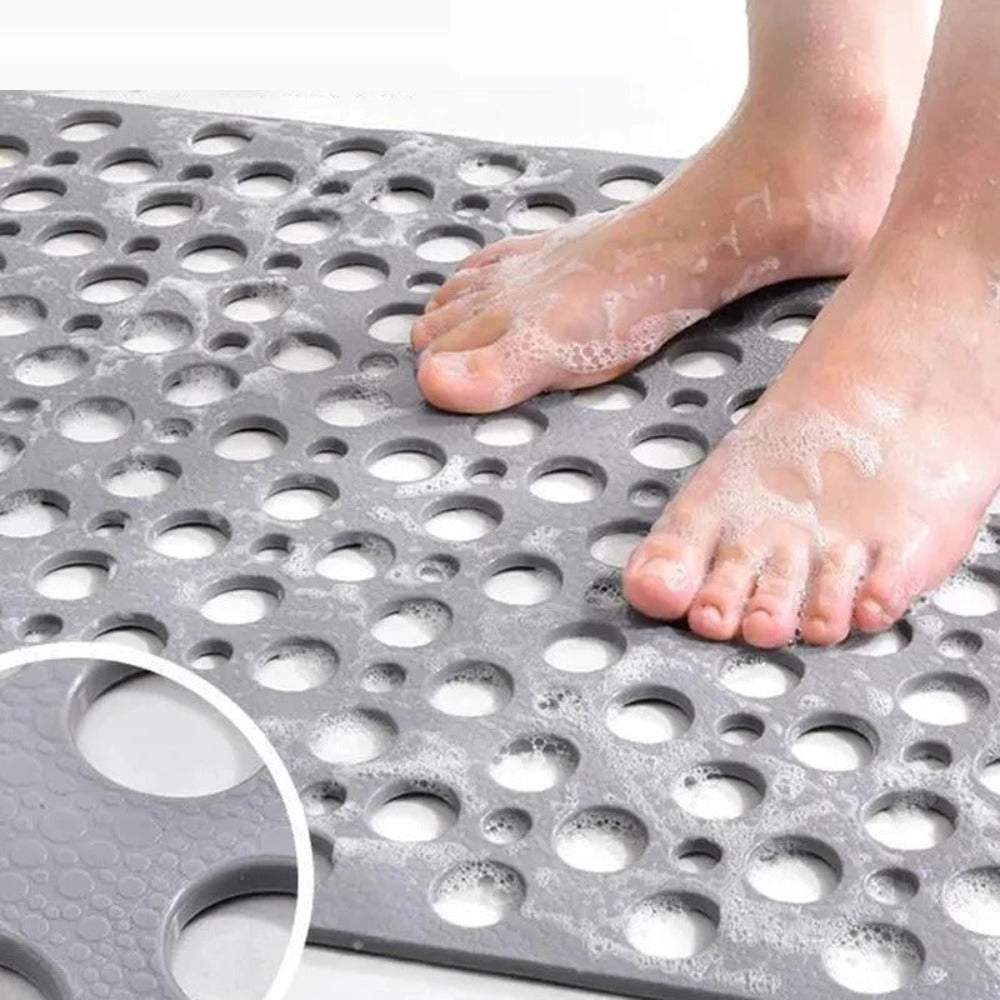 Non-slip shower mat with suction cups, textured for comfort, mold-resistant, in blue, green, grey; enhances bathroom safety.