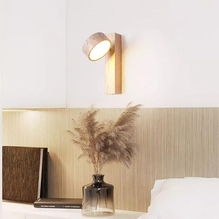 "Off-white travertine wall lamp with LED light, minimalist design, wood accents, ideal for ambient bedroom lighting."