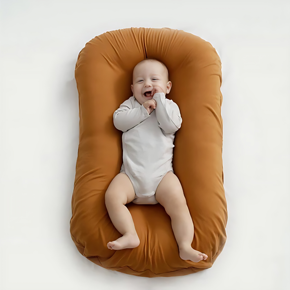 Orthopedic baby cushion in pink, supportive ergonomic design for healthy sleep, prevents flat head syndrome, soft material.