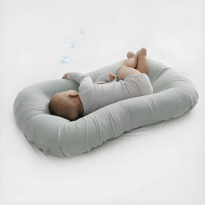 Orthopedic baby cushion in pink, supportive ergonomic design for healthy sleep, prevents flat head syndrome, soft material.