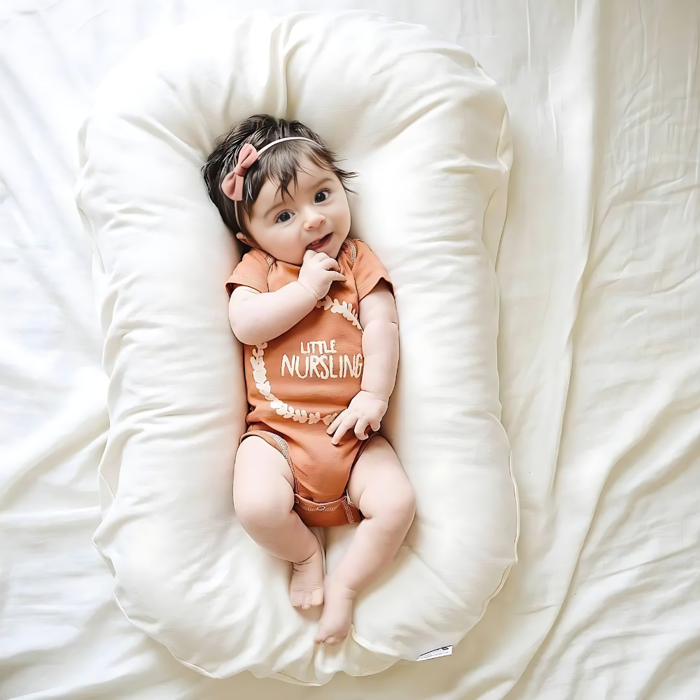 Orthopedic baby cushion in pink, supportive ergonomic design for healthy sleep, prevents flat head syndrome, soft material.