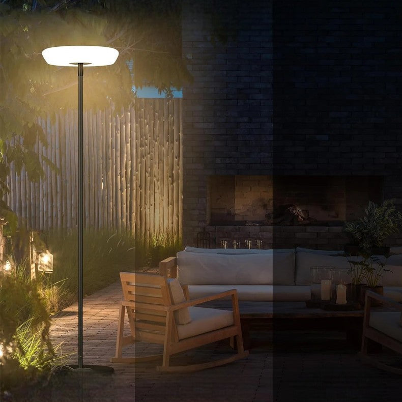 Outdoor solar floor lamp with metal and acrylic body, modern design, stands on patio illuminating with warm LED glow.