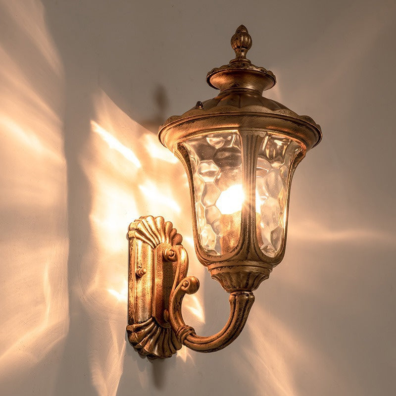 "Outdoor waterproof bronze wall light with clear water glass shade, elegant design for stylish exterior lighting."