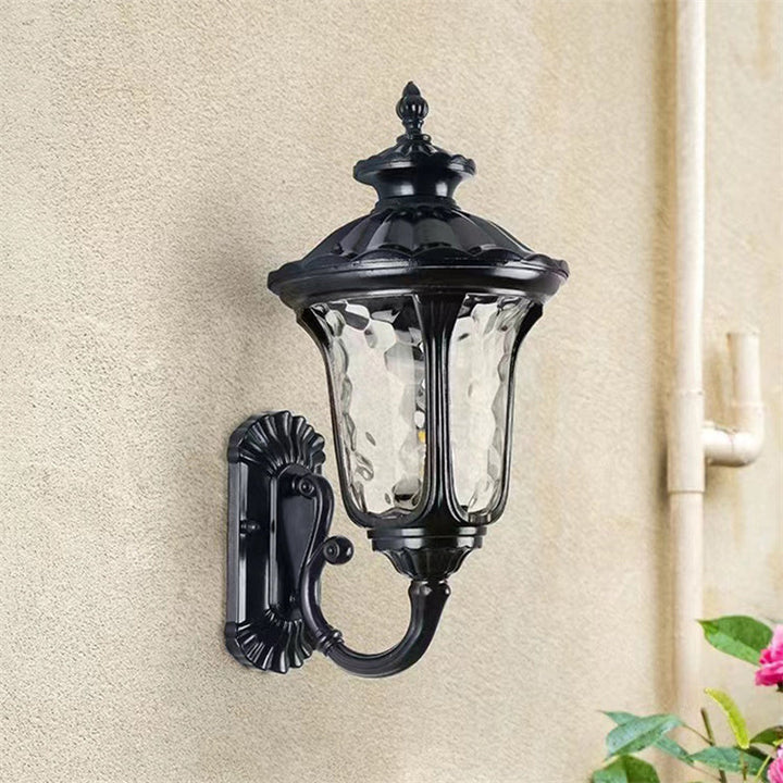 "Outdoor waterproof bronze wall light with clear water glass shade, elegant design for stylish exterior lighting."