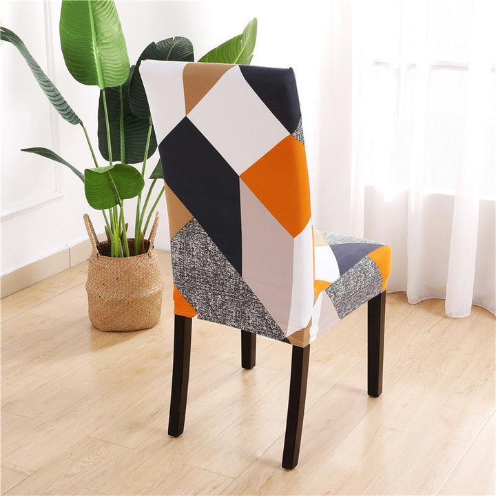Patterned prismatic chair cover enhancing elegance; high-elasticity, anti-slip, durable fabric for stylish home décor.