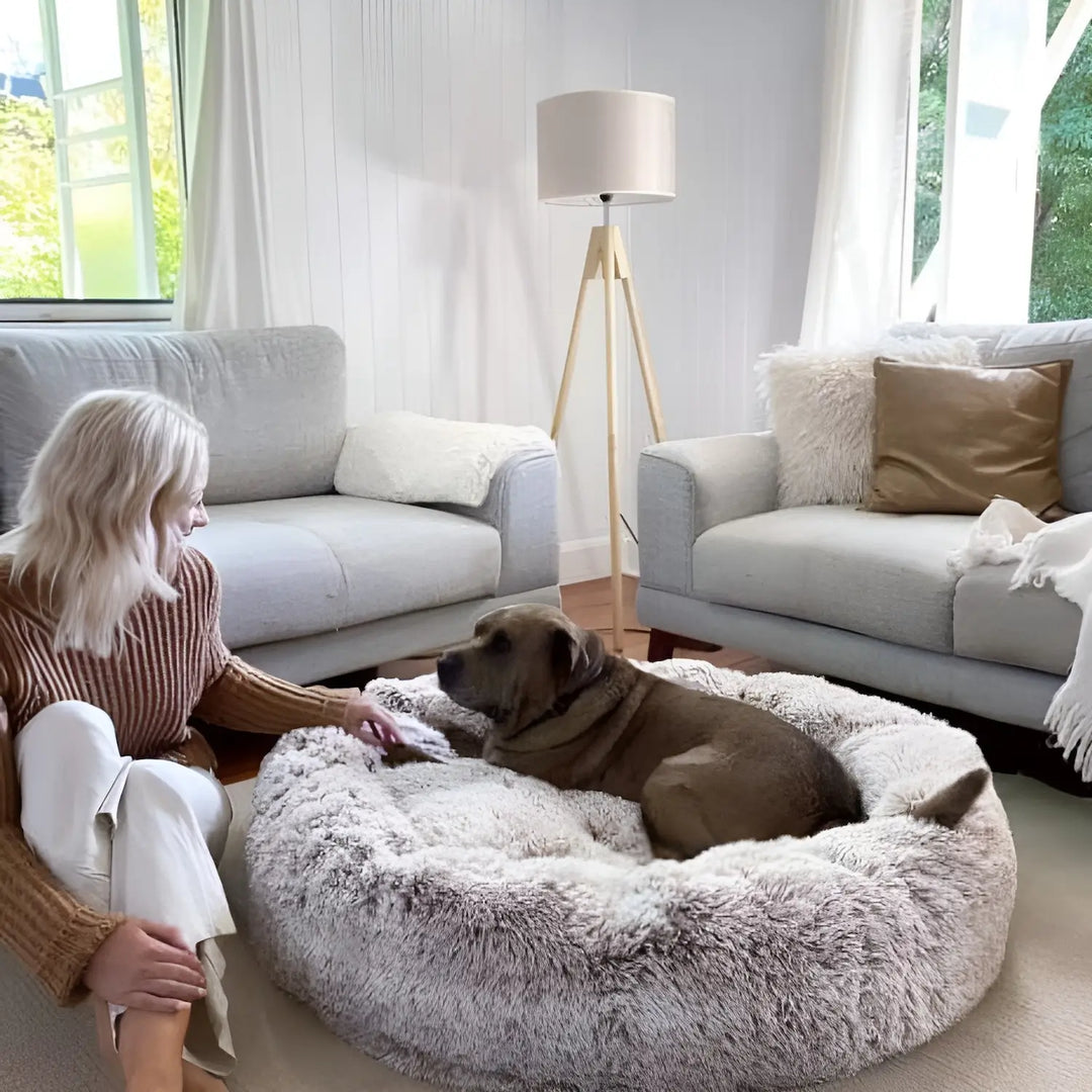"Plush luxury dog bed for anxiety relief in apricot color, round with raised rim, available in multiple sizes."